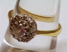 A high grade yellow metal centre small brilliant cut Diamond and small Diamond surround Cluster Ring