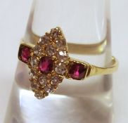 A high grade precious metal marquise design Cluster Ring set to the centre with a blood red Ruby