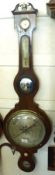 A 19th Century Rosewood Wheel Barometer, the swan neck pediment with Ivory or composition detail and