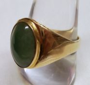 A yellow metal single Cabochon Jadite stone, signet style, stamped “375, 9k”.