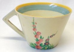 A Clarice Cliff conical Cup, decorated with the “Hollyhocks” pattern.