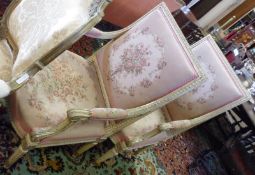 A pair of 19th Century Armchairs, with cream painted frames, swept arms and upholstered in floral