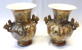 A pair of Satsuma Two-Handled Baluster Vases, painted in colours with panels of immortals and