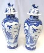 A near pair of Oriental Covered Vases of tulip baluster form, each painted in colours with Kaolin