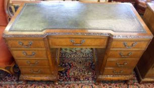A Walnut veneered twin pedestal Desk, with green tooled Leather inset, each pedestal with four