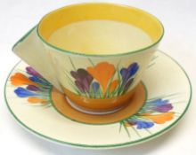 A Clarice Cliff conical Cup and Saucer, decorated with the “Crocus” design.