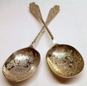 A good pair of Victorian Serving Spoons, the oval gilded bowls each depicting a peacock with foliate