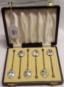 An attractive cased set of six Elizabeth II Silver gilt Coffee Spoons, each with an enamelled back