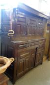 A large Oak Court Cupboard constructed of period timbers, the top with three panelled doors, the