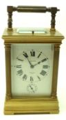 A late 19th Century French lacquered Brass Carriage Clock with repeating and striking Alarm