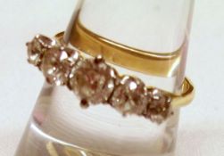 An unmarked precious metal five stone old cut Diamond Ring of approximately 1ct total, the centre