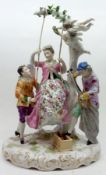 An early 20th Century Rudelstadt arbour Figure Group of a Female Figure on a Swing with two Male