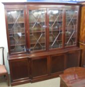 A reproduction Mahogany break front Bookcase Cabinet in the Regency style, the top section with four