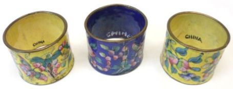 A collection of three Oriental enamelled Napkin Rings, one decorated in famille rose and verte on