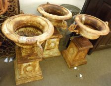 A set of three 20th Century Cast Iron Garden Urns on square Iron columns, (heavily rusted and