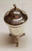 An Edwardian period three footed Pepper of acorn shape, the slightly domed lid with curved finial, 3