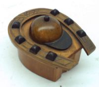 A small flip-top Box, the top decorated with a carved horseshoe design and jockeys cap, 4” long