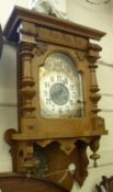 A late 19th Century Oak cased art nouveau style Wall Clock with Junghans striking movement, the