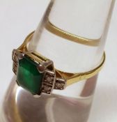 A vintage high grade precious metal centre emerald cut Emerald and six small Diamond Ring in Art