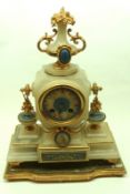 An elegant French Alabaster mantel Clock crested with a gilt metal mounted urn finial, inset with