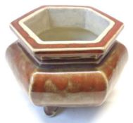 An Oriental lustre glazed formerly covered Pot of hexagonal form, (lid missing), raised on three