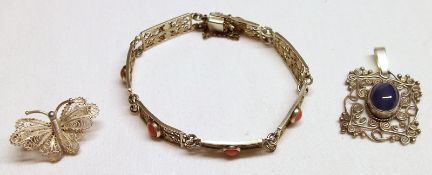 A filigree white metal Bracelet with pink coral mount together with a filigree butterfly Brooch