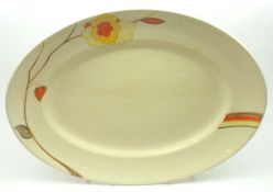 A Clarice Cliff Bizarre oval Meat Plate, decorated with single floral spray on a cream background,