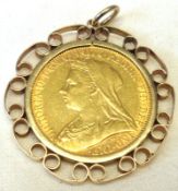 A Victorian Gold Sovereign dated 1894 within a yellow metal scroll design Pendant Holder stamped “
