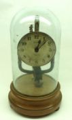 An early 20th Century 800-day Clock, Pinchin Johnson, by Bulle Clocks, under a glass dome on a Treen