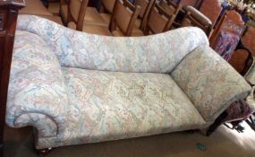 A Victorian Chaise Longue with sloped back, upholstered in an abstract patterned fabric, (some