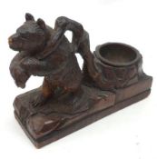 A 20th Century carved Soft Wood Black Forrest style Pipe Stand modelled as a bear carrying a tree,