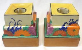 A pair of Clarice Cliff Candlesticks of stepped square form, decorated with the “Gayday” pattern (