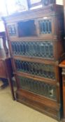 A Globe Wernicke four tier stacking Bookcase with leaded glazed doors and single drawer to base, (