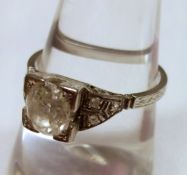 An unmarked precious metal old cut Solitaire Diamond Ring, approximately 1ct and set with further