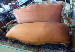 A 19th Century French styled Walnut and parcel gilt Sofa, upholstered in pink Draylon, with