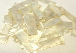 A packet of 26 Oriental Mother of Pearl Gaming Counters, rectangular and square shaped, all with