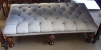 A large fabric covered deeply buttoned Footstool, raised on a six legged Bobbin turned frame, 48”