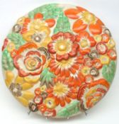 A Clarice Cliff Wilkinsons England Limited floral embossed China Wall Plaque, decorated in yellow,