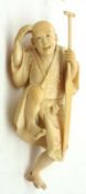 A humorous Oriental Ivory Model of a Riverboat Man with a large paddle, (losses), 4 ½” long.