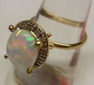 A hallmarked 9ct Gold large centre Opal and small brilliant cut Diamond surround Cluster Ring, the