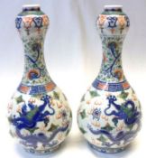 A pair of 19th Century Chinese (Kangxi) bottle shaped Vases, well painted in iron red, famille verte