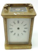 A late 19th/early 20th Century French lacquered Brass Carriage Timepiece, with platform