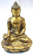 An Oriental gilded Bronze Figure of a seated Deity clutching a Sensor in his left hand and wearing