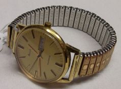 A last quarter of the 20th Century Gold Plated Quartz Centre Seconds Calendar Wristwatch,