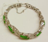 An unmarked precious metal ten Emerald Jade and forty-two Diamond set Bracelet, approximately 4.5 ct