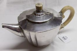 A George VI Tea Pot of hammered construction and tapering square form, with shaped corners, pull-off