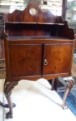 A small Mahogany Pot Cupboard, the shaped back with carved shell detail, to a small shelf, galleried