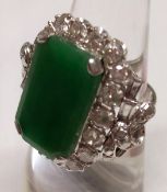 A Platinum rectangular Emerald Jade panelled Ring with eighteen brilliant cut Diamonds in