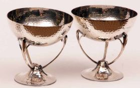 A good pair of Edward VII Arts & Crafts style Bon-Bon Dishes, the circular spot-hammered bases