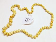 A polished graduated pale Amber bead Necklace, 62cm long.